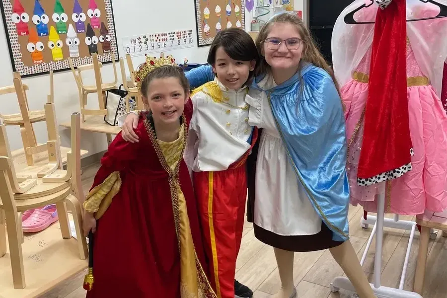 Three Centerstage Players in costume backstage at Spark Academy's After-School Enrichment program
