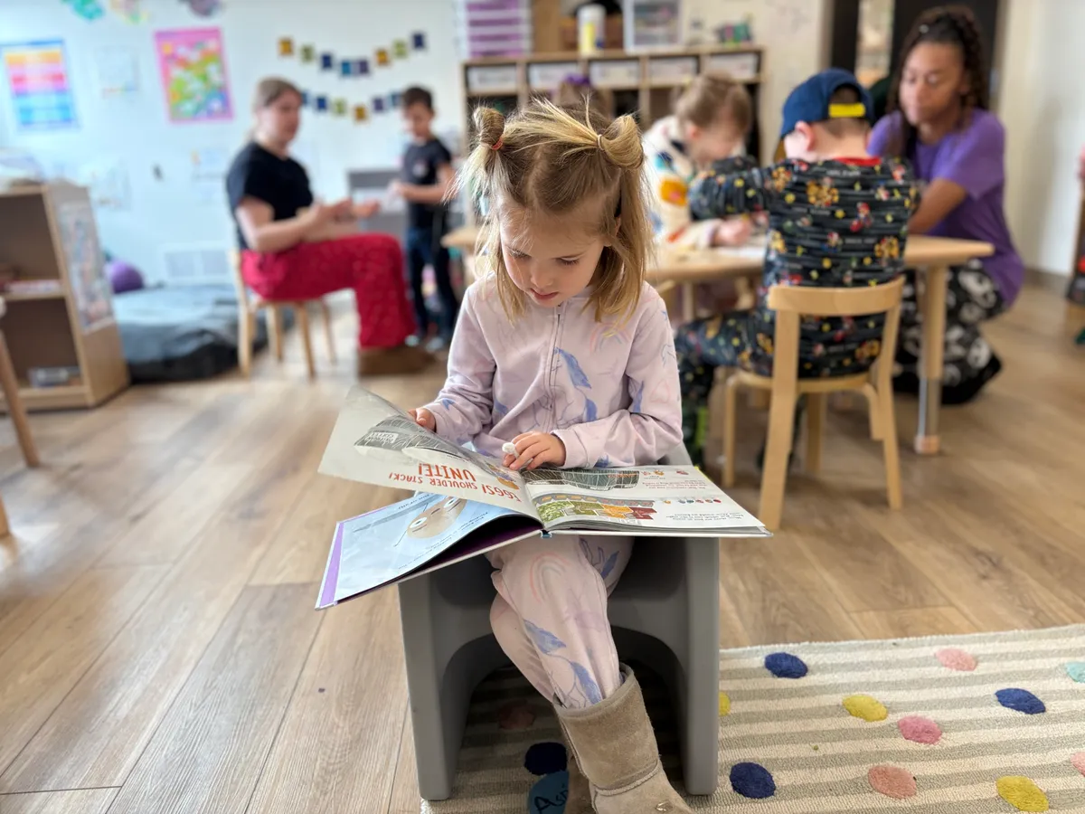 Spark Academy interior showing warm, homelike environment with child-sized furniture and organized learning materials
