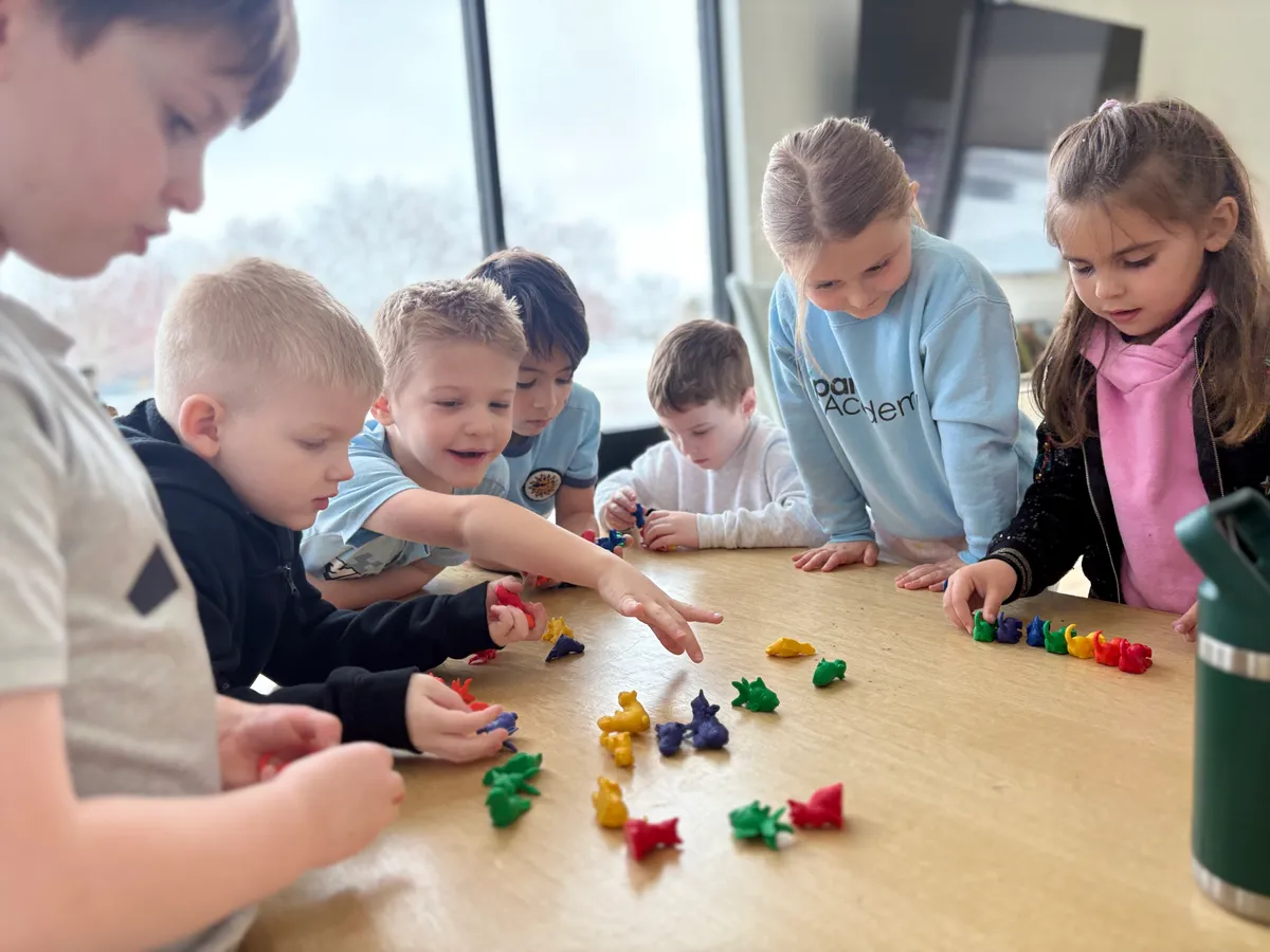 Children exploring hands-on learning materials together at Spark Academy