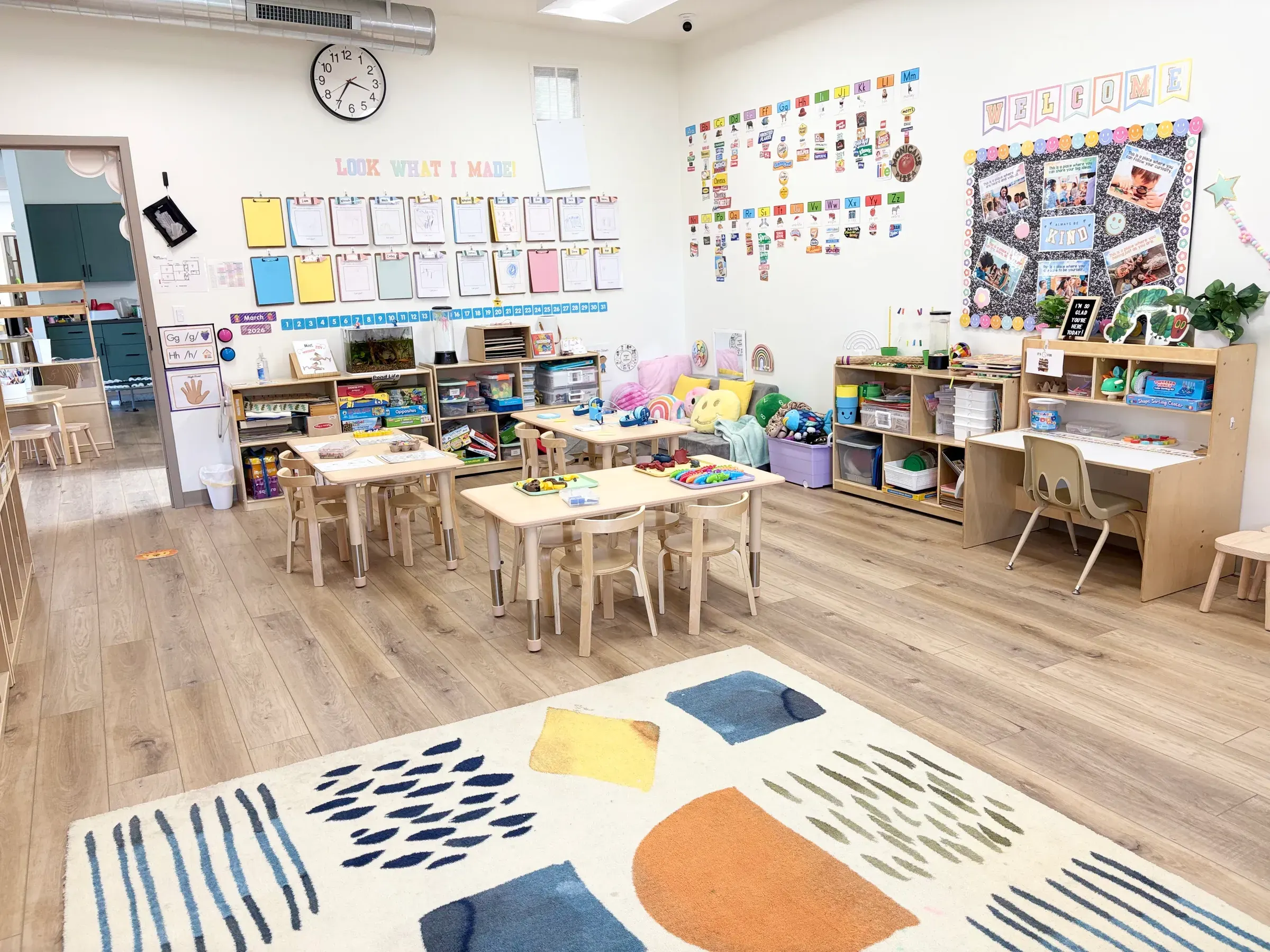Inside Spark Academy preschool — organized classroom with child-sized tables, learning materials, and natural light