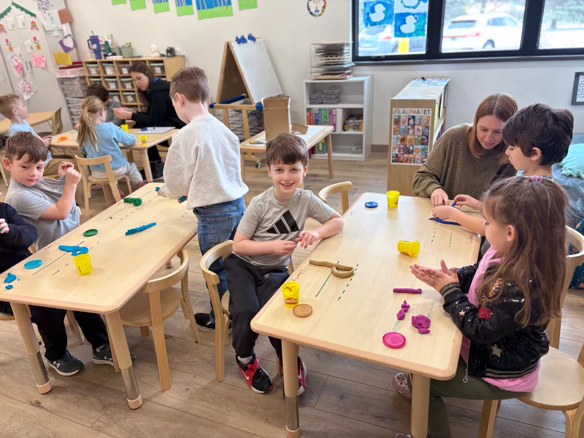 Spark Academy student forming letters from Play-Doh during a kindergarten readiness activity