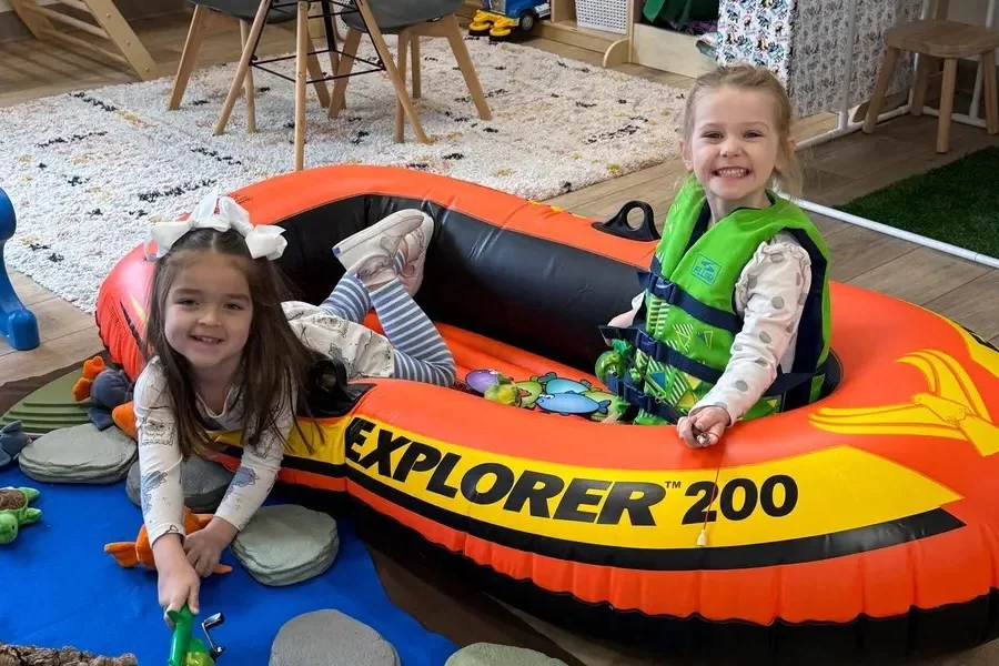Children in the Developmental Playroom at Spark Academy — ocean adventure theme with inflatable boat