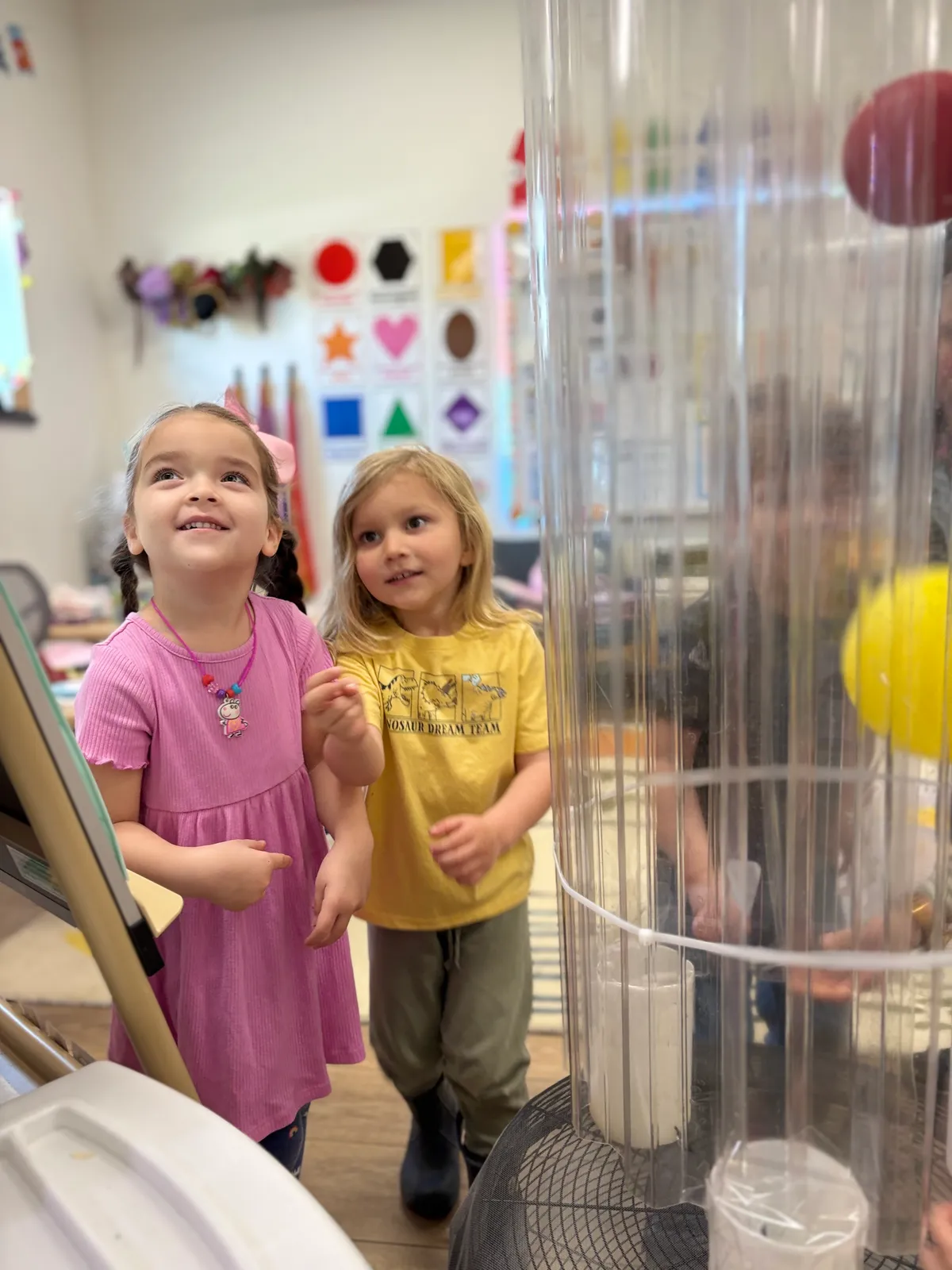 Children watching a science vortex tube with wonder during STEM enrichment at Spark Academy
