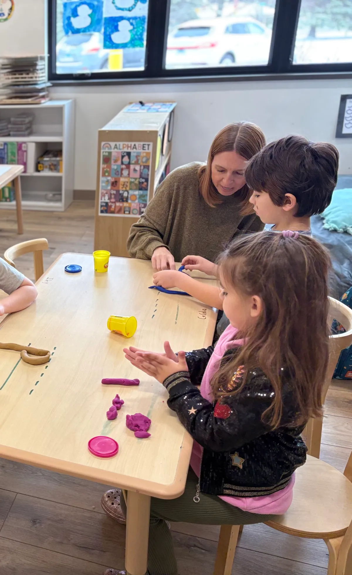 Spark Academy teacher working individually with students during Academic Play