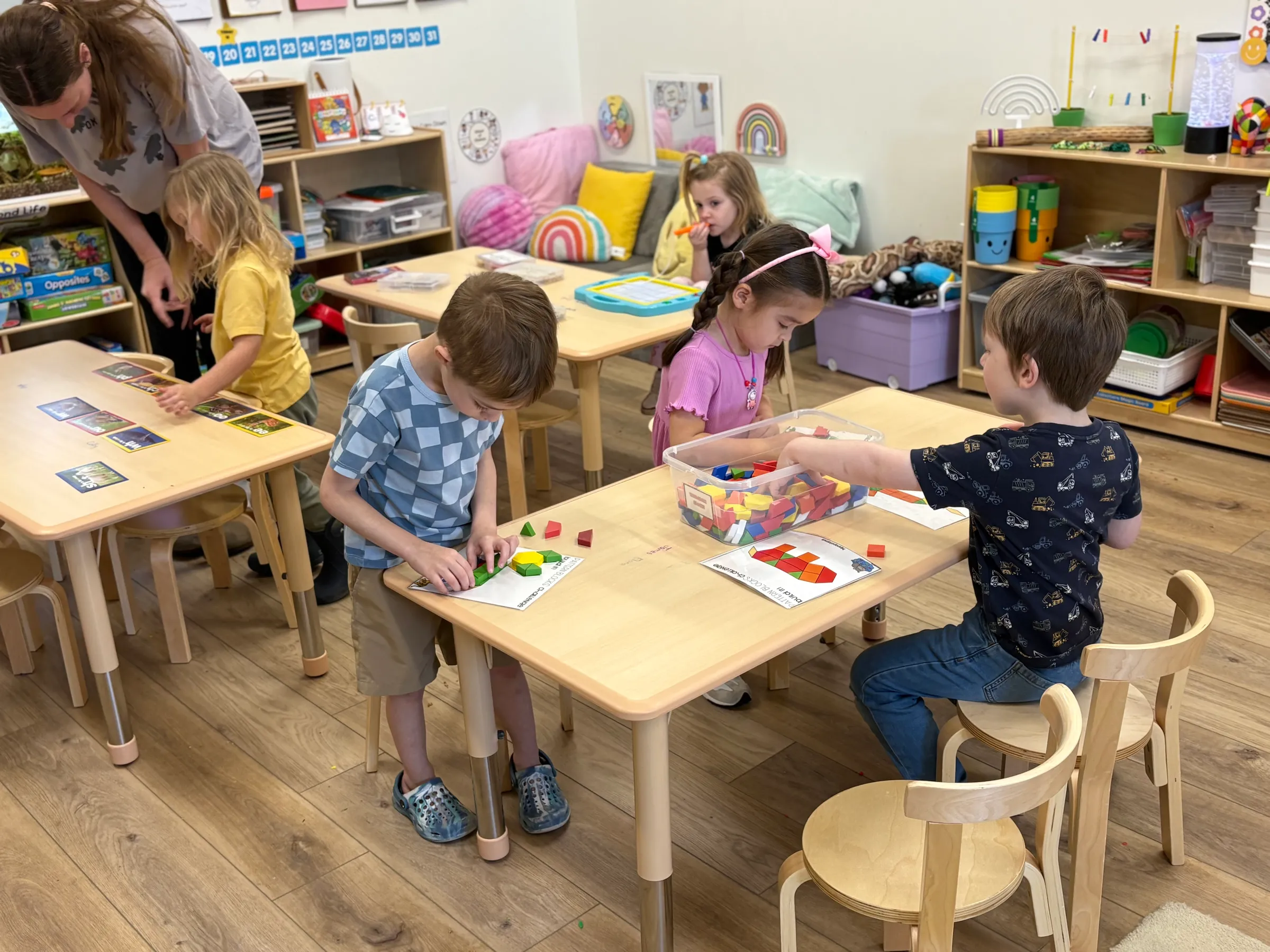 Three-year-old children engaged in hands-on learning activities at Spark Academy preschool in Morton, Illinois